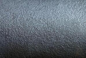 Close-up of dark metallic surface with rough texture, ideal for industrial design, backgrounds, and material projects. photo