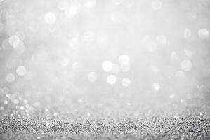 Abstract silver glitter background with defocused bokeh lights, perfect for festive or elegant designs. photo