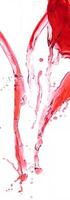 Dynamic splash of red liquid in midair on a white background, creating fluid and abstract shapes. photo