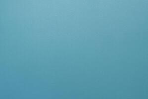Simple minimalist blue textured background with a smooth surface, perfect for design projects. photo