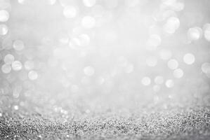 Abstract silver glitter background with defocused bokeh lights, perfect for festive or elegant designs. photo