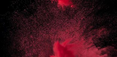 Close-up of abstract red powder explosion against a black background, ideal for creative or dynamic design projects. photo