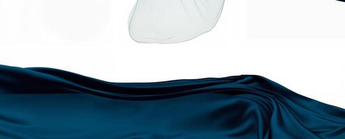A flowing dark blue fabric elegantly draped on a white background, creating a smooth and abstract visual effect photo