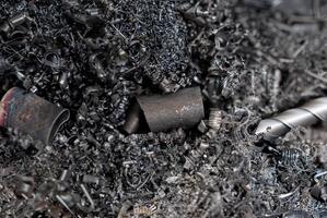 A detailed close-up of metal shavings and scrap from machining, showcasing intricate textures and industrial waste photo