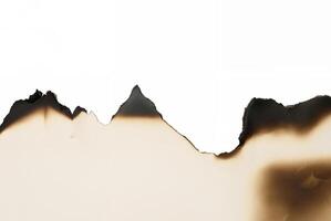 Burnt paper edge with jagged, torn, and scorched border isolated on white background, perfect for design. photo