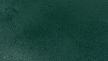 Dark green textured background with rough surface, suitable for design or text overlay. photo