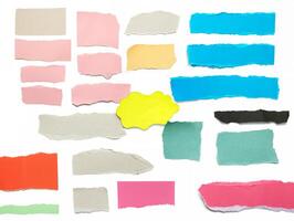 A variety of colorful torn paper pieces in blue, pink, green, and beige, isolated on a white background, ideal for design use photo