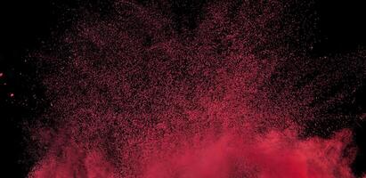 Close-up of abstract red powder explosion against a black background, ideal for creative or dynamic design projects. photo