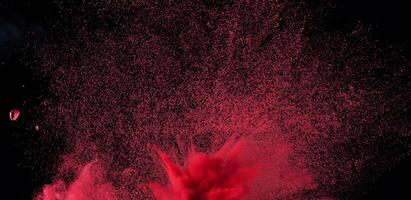 Close-up of abstract red powder explosion against a black background, ideal for creative or dynamic design projects. photo