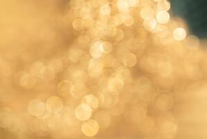 Abstract golden bokeh light background, perfect for festive, holiday, or celebratory themes in design and decoration. photo