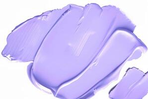 Close-up of a smooth purple smear of paint or cosmetic cream isolated on a white background, ideal for design or beauty-related concepts. photo