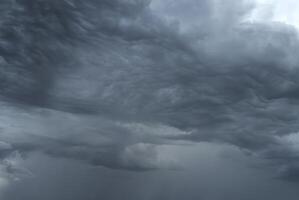 Dark, ominous storm clouds forming in the sky, signaling impending heavy rain. photo