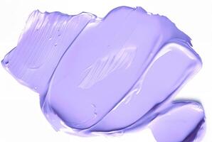 Close-up of a smooth purple smear of paint or cosmetic cream isolated on a white background, ideal for design or beauty-related concepts. photo