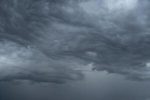 Dark, ominous storm clouds forming in the sky, signaling impending heavy rain. photo