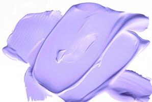 Close-up of a smooth purple smear of paint or cosmetic cream isolated on a white background, ideal for design or beauty-related concepts. photo