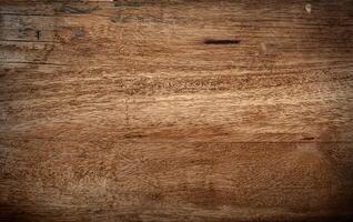 A close-up view of a natural wooden surface with rich grain patterns and slight imperfections, perfect for backgrounds, textures, or design projects. photo