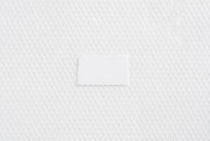 Close-up of white textured paper with a subtle, woven-like pattern, ideal for use as a background or design element. photo