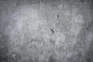 Close-up of a rough gray concrete wall texture, ideal for backgrounds or construction-related projects photo