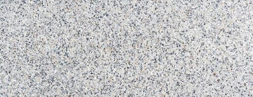 Close-up of terrazzo floor texture featuring mixed stone chips, ideal for architecture, flooring, and design projects photo