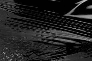 de cerca de resumen negro lustroso el plastico textura con liso, reflexivo superficie, Perfecto para antecedentes o diseño conceptos foto