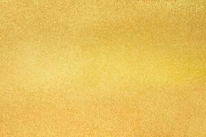 Close-up of gold glitter texture with a shimmering surface, perfect for festive backgrounds, design, and luxury themes photo