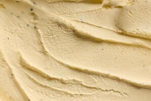 Close-up of creamy vanilla ice cream texture with smooth swirls, showcasing rich and indulgent dessert photo