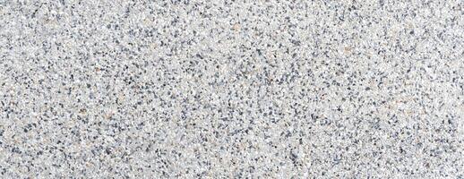 Close-up of terrazzo floor texture featuring mixed stone chips, ideal for architecture, flooring, and design projects photo