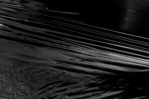 de cerca de resumen negro lustroso el plastico textura con liso, reflexivo superficie, Perfecto para antecedentes o diseño conceptos foto