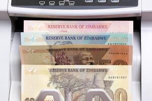 Zimbabwean dollar in the counting machine photo