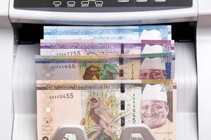 Gambian dalasi in the counting machine photo