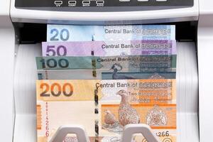 Gambian dalasi in the counting machine photo