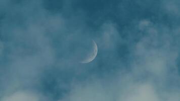 Half Moon in the sky behind the clouds video