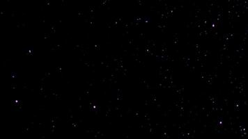 Purple sparkles floating in the air overlay video