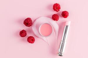 Cosmetic balm in a tube and round jar with a delicate structure on a pink background for lip care. A unique berry complex. Pleasant raspberry aroma. photo