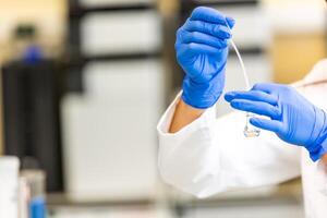 Young woman scientist in a research laboratory creating a scientific experiment, laboratory concept photo