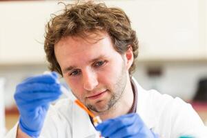 Young scientist in a research laboratory creating a scientific experiment, laboratory concept photo