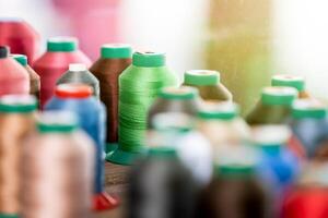 Close up of colorful threads in the leatherworking or tailoring studio photo