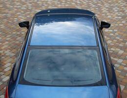Ongoing View From Above On The Roof Of Blue Car photo