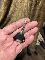 entrance door with a handle, a key inserted into the keyhole photo