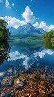 Glassy lake reflects majestic mountain and clouds. photo
