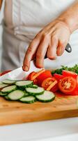 Slicing vegetables with precision on a wooden cutting board. Healthy cooking and kitchen tips. photo
