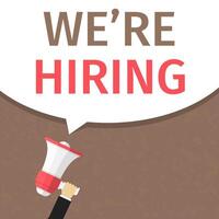 Hand holding megaphone and speech bubble with text We're hiring vector