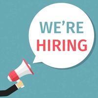 Hand holding megaphone and speech bubble with text We're hiring vector