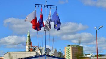 Szczecin, Poland. 14 September 2024. The flags of Poland, Szczecin, WOPR and the European Union waving against the blue sky photo