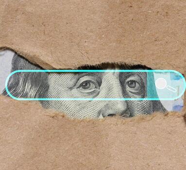 A fragment of a hundred dollar bill partially hidden under a layer of torn paper. Concept of finding or revealing information about money, financial data or hidden aspects of the economy photo
