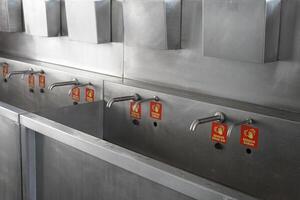 hand washing taps with sensors for the public and sensor tap signs photo