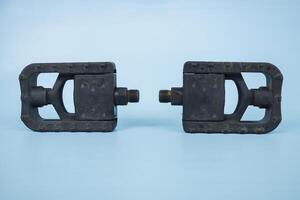 folding bicycle pedals, part of a folding bicycle, isolated on blue background photo