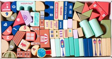 The wooden building blocks are painted in colorful colors and have public places written on them photo