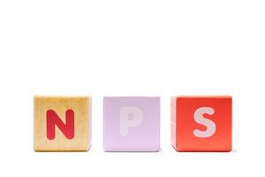 text NPS NET PROMOTER SCORE on colorful wooden isolated on a white background photo