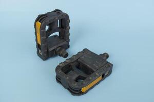 folding bicycle pedals, part of a folding bicycle, isolated on blue background photo